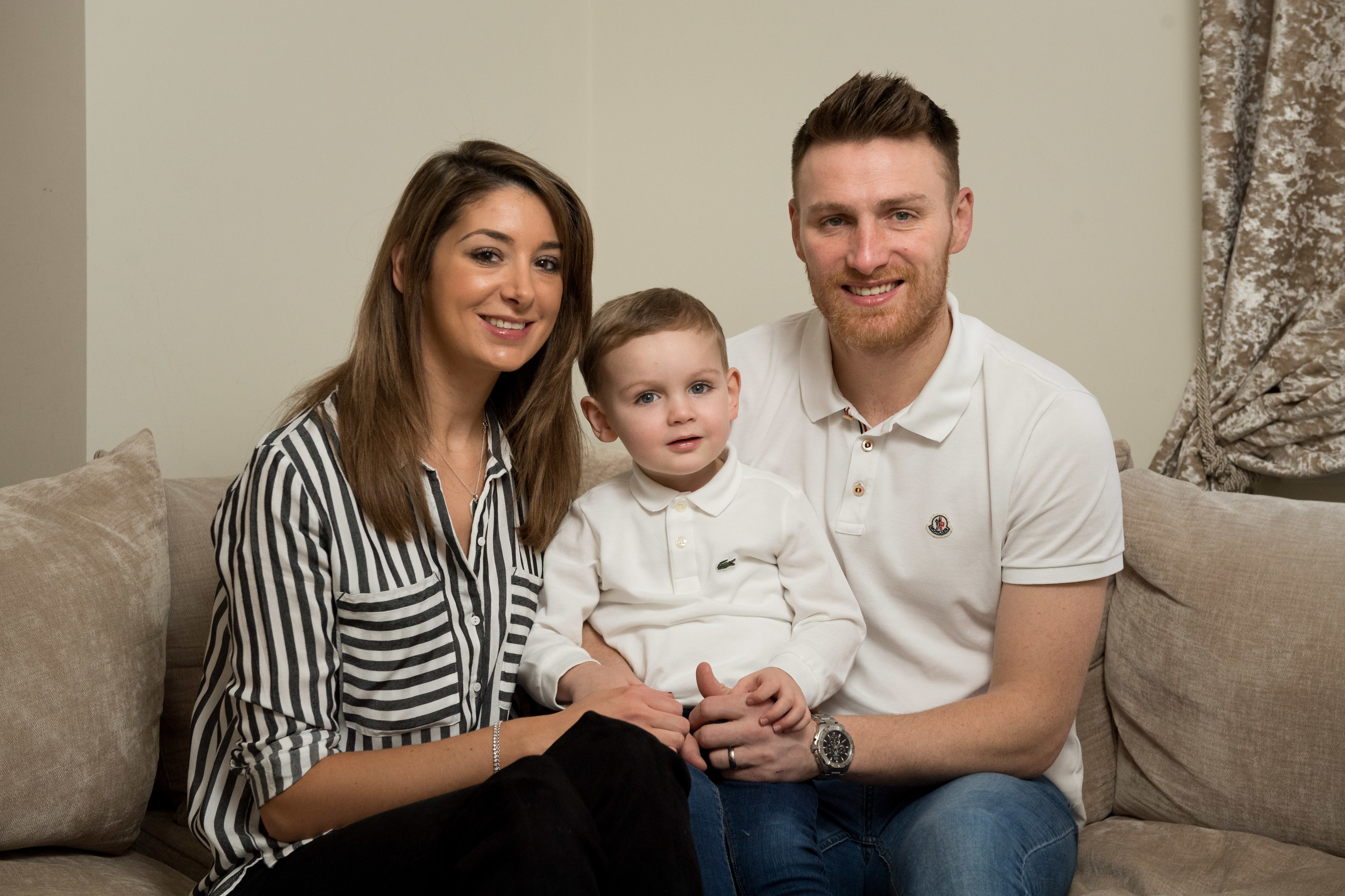 Pictured is Noel with his parents: Peterhead footballer Rory McAllister and wife Ashley.