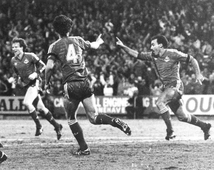 A delighted Willie Miller right) celebrates his opening goal for Aberdeen.