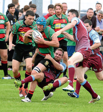 Highland RFC V St Boswells RFC BT Cup First Round
It takes some desperate tackling to stop Highland's Stuart MacDonald.
Pic - Phil Downie