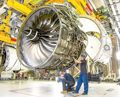 Technicians work on a Rolls-Royce Trent XWB engine.