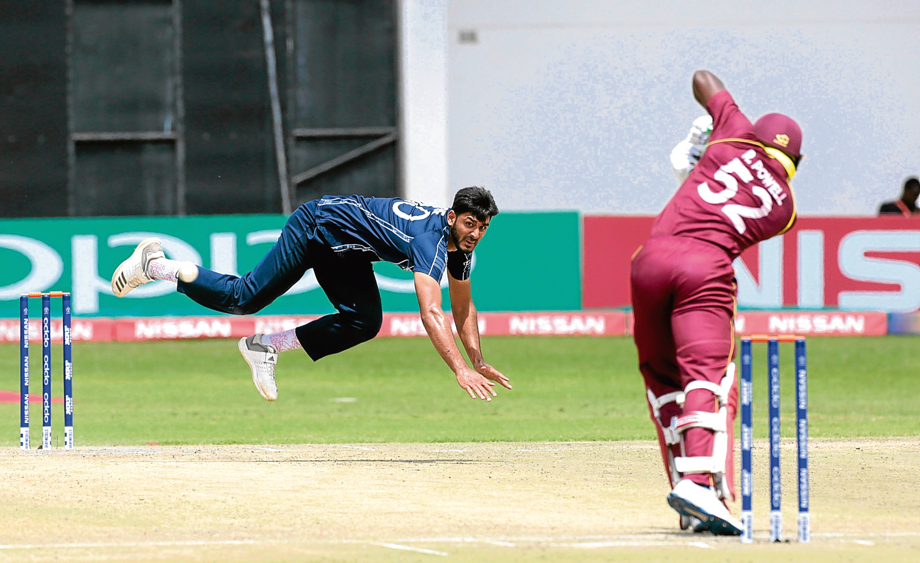 Scotland   bowler  Safyaan Sharif ,centre,  in action during their  cricket world cup qualifier match against West Indies at Harare  Sports Club, Wednesday, March, 21, 2018.Zimbabwe is playing  host to  the 2018  Cricket World Cup Qualifier matches  featuring  10 countries.(AP Photo/Tsvangirayi Mukwazhi)