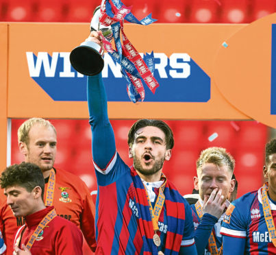 Inverness' George Oakley lifts the IRN-BRU Cup