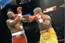 George Foreman (left) and Michael Moorer trade blows during a bout in Las Vegas, Nevada