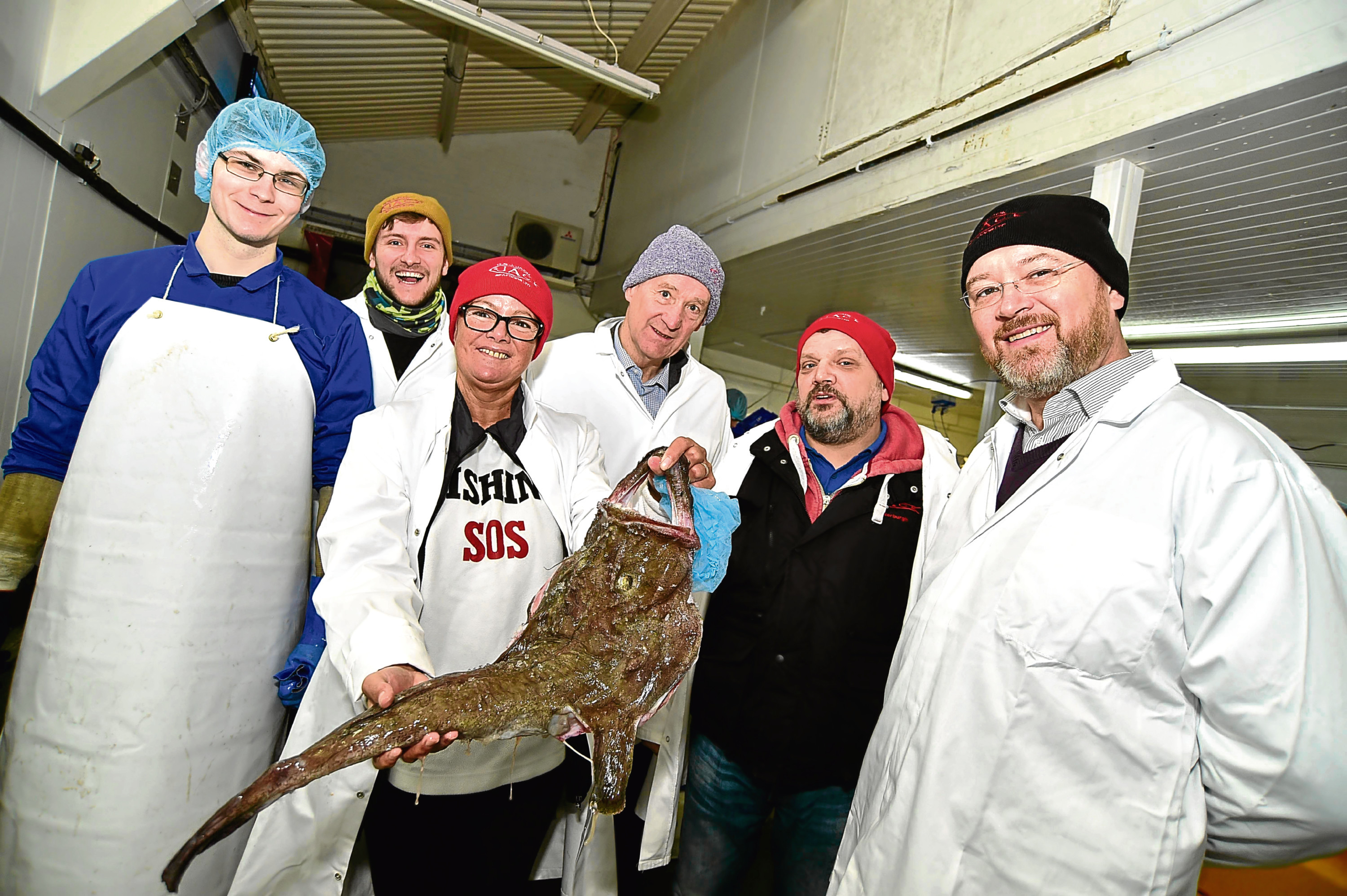 Carol MacDonald shows a monkfish during a tour of G&J Jack's fish processing plant in Fraserburgh.