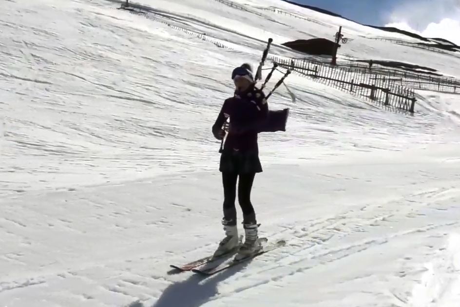 The footage shows the piper sking downhill whilst blowing a tune at the Glenshee Ski Centre.
