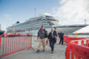 Tourists disembark from the cruise ship MV Columbus during her maiden call at Lerwick Harbour