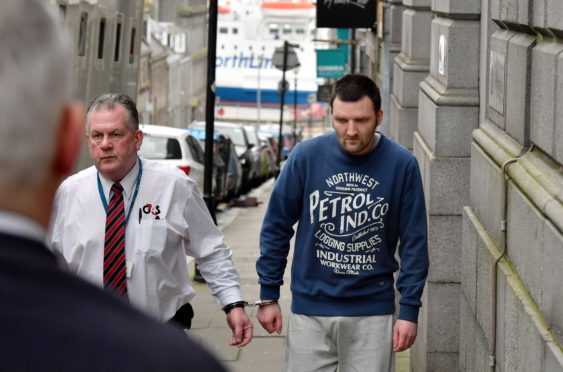 Mark Bruce is led away at court.