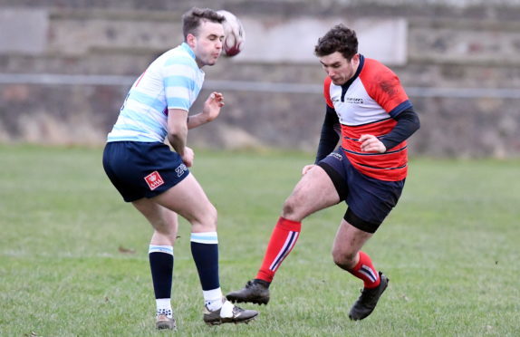 Aberdeen Grammar's Doug Russell kicks past Callum Ramm.