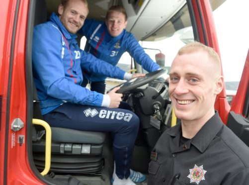 Inverness firefighter Conor Cormack in safe hands yesterday with Caley Thistle goalkeepers Mark Ridgers (left) and Cameron Mackay.
Picture by Sandy McCook.