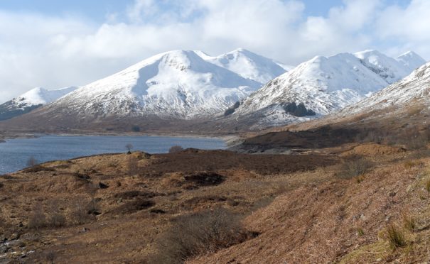 Loch Cluanie in Inverness-shire with its surrounding hills covered in snow.