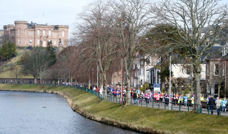 Runners in both races make their way past Inverness Castle.