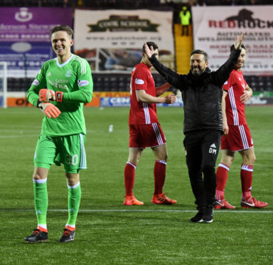 Aberdeen's Freddie Woodman celebrates after the shootout.