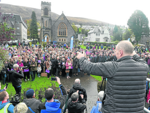 The Massed Choirs are led through Fort William by the Lochaber Pipe Band before performing on The Parade in the centre of the town before making their way home following the Royal National Mod.