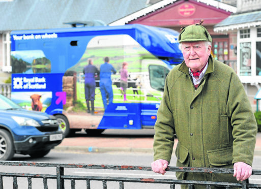 Joe Taylor, Kingussie Community Council Chairman outside the Royal Bank of Scotland van in the town which is having its stopping times reduced as part of the bank closures programme.