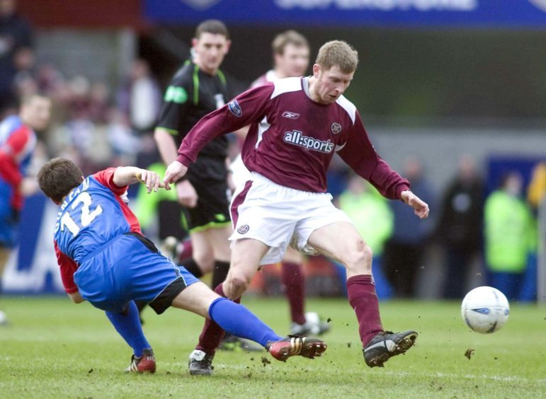 Wyness takes on ICT in a Hearts jersey.