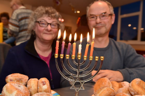 The Jewish community in Aberdeen celebrated Hanukkah  in
Summerhill Church this year because their synagogue had been flooded. 
Picture of Debby and Mark Taylor (head of Aberdeen Synagogue) with the Menorah. 
Picture by KENNY ELRICK
