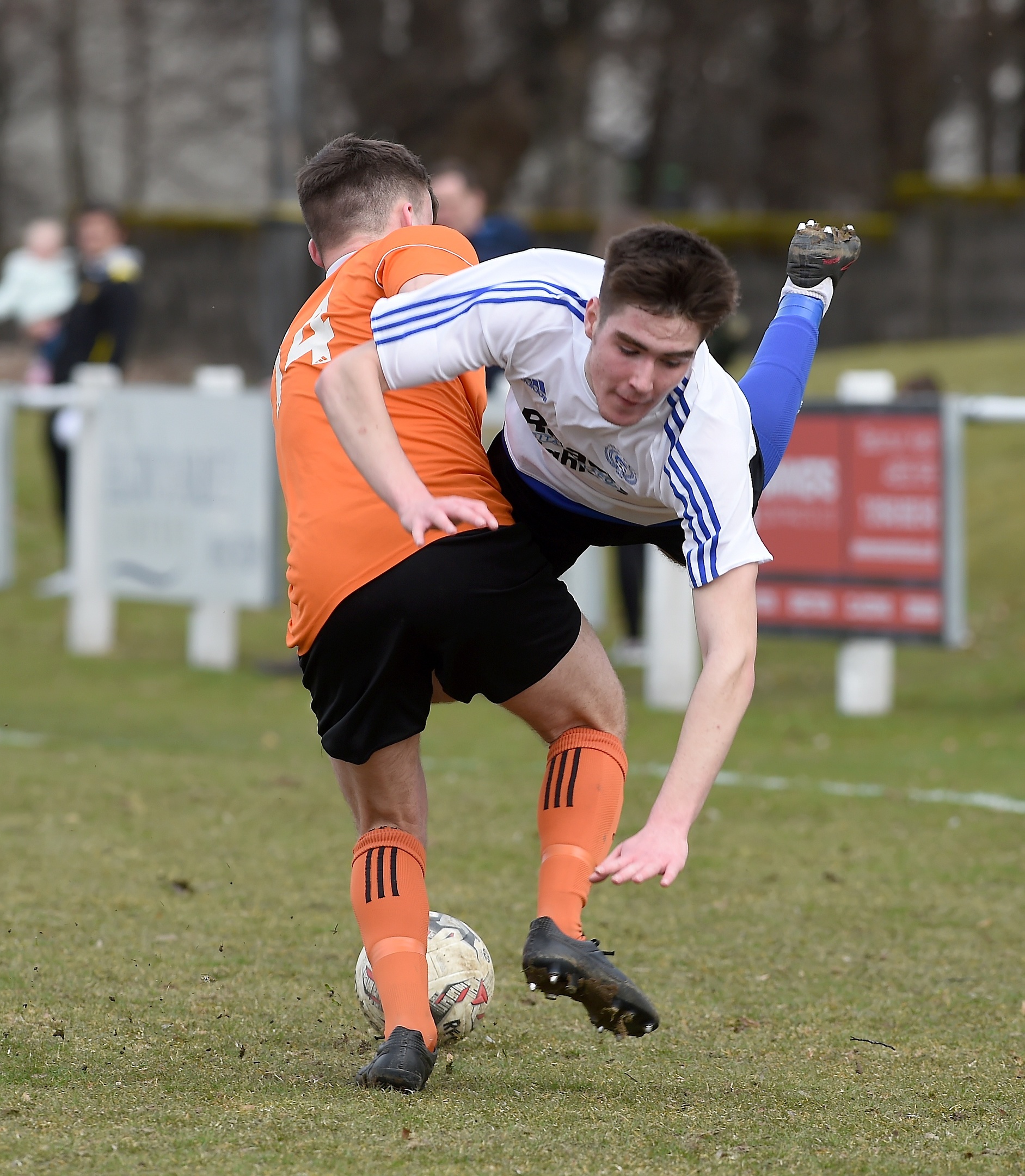 Nairn County's Max Ewan is upended by Rothes' Blair Maclennan.