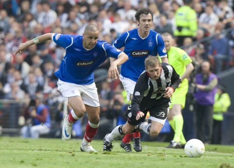 Rangers duo Madjid Bougherra (left) and Christian Dailly crowd out Dennis Wyness in 2009.