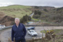 Helmsdale based consulting civil engineer Colin Mackenzie with Berriedale Braes in the background.