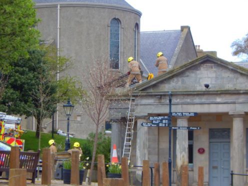 Crews remove the bench from the roof. Picture: Reg Connon.