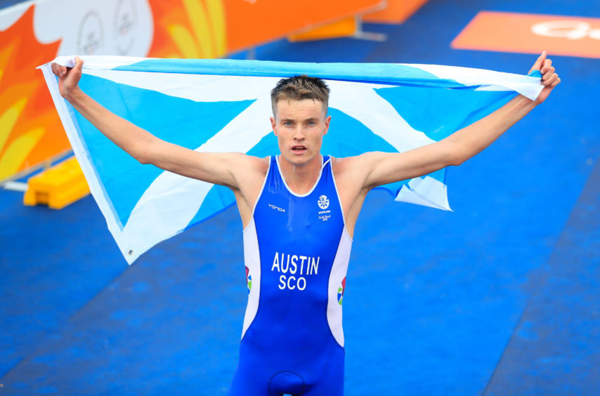 Scotland's Marc Austin celebrates after winning bronze in the Men's Triathlon Final.