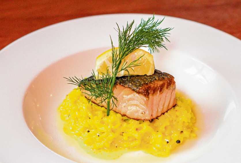 Pan fried fillet of salmon on a bed of risotto finished with white wine and cream