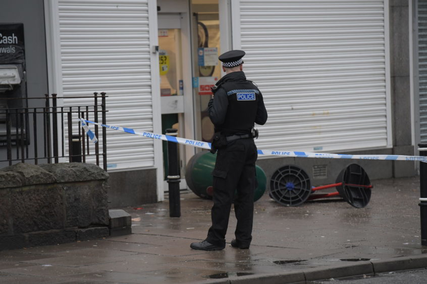 Police attend the scene of a robbery at the Spar on Clifton Road last month.