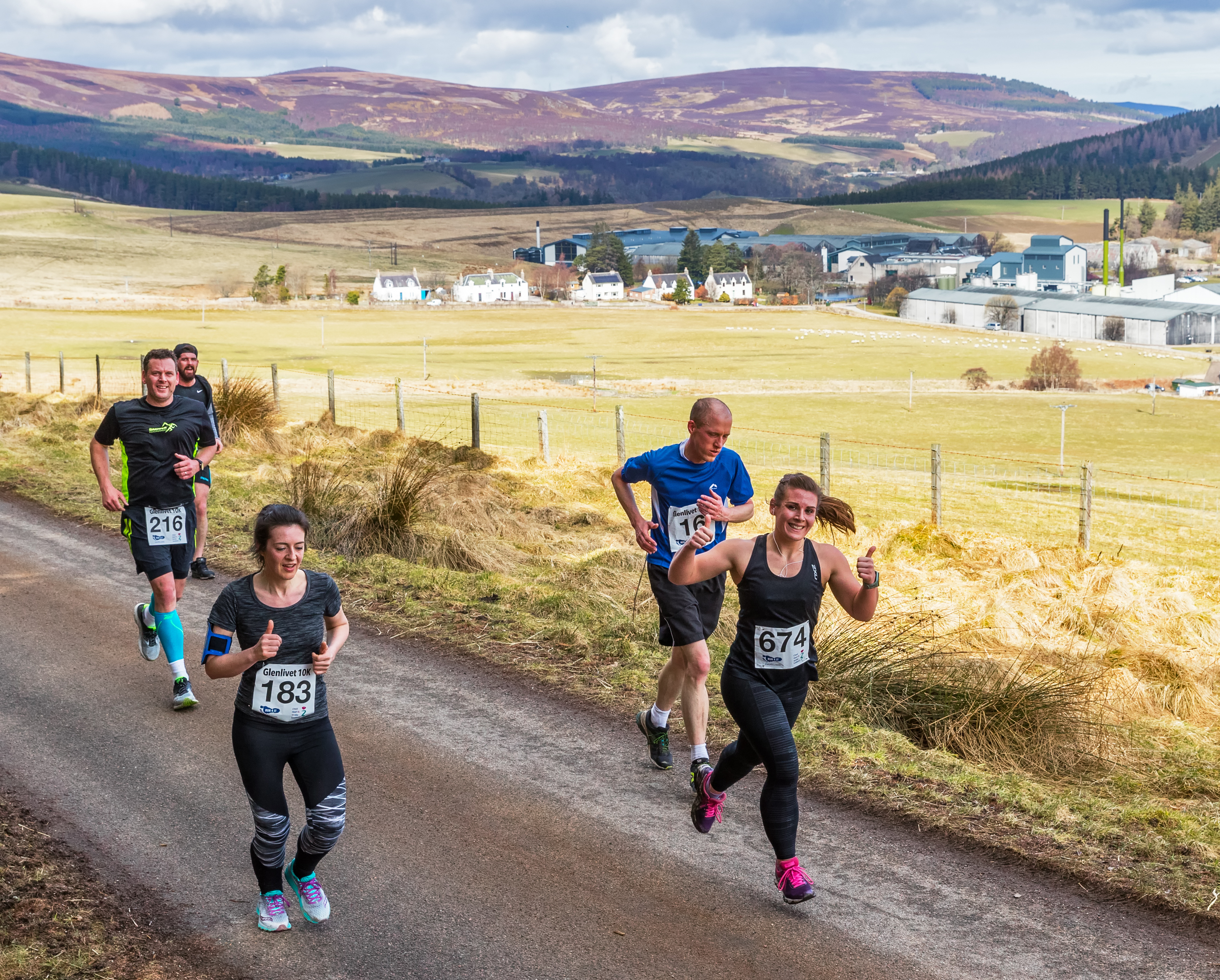 Runners reach the top of the incline and give a thumbs up during the Glenlivet 10K yesterday.