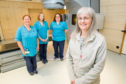 Helen Homer, (centre) is pictured with  members of the radiotherapy treatment team at Raigmore Hospital in Inverness.