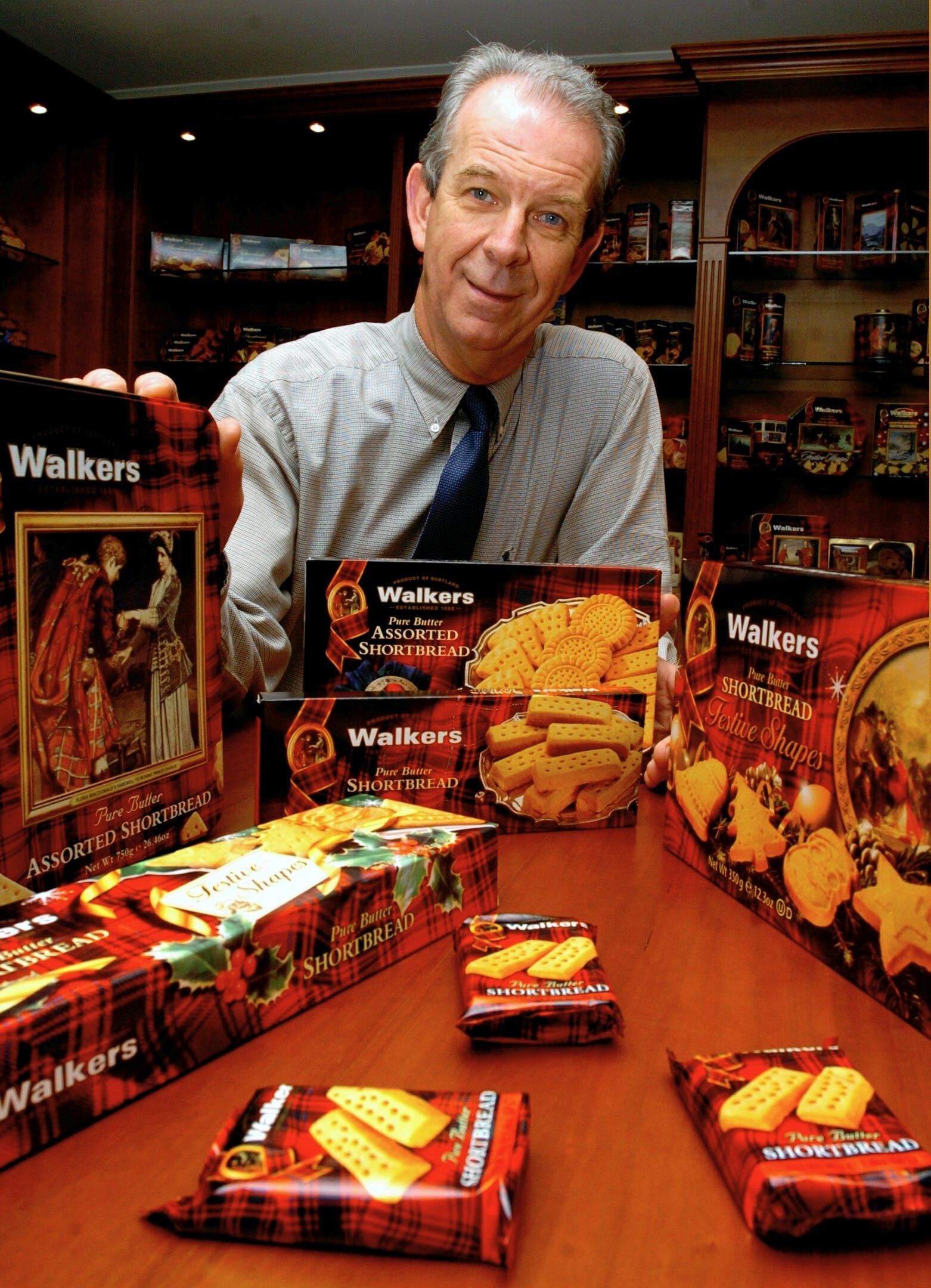 Sir Jim Walker with Walker's Shortbread products at the Aberlour factory