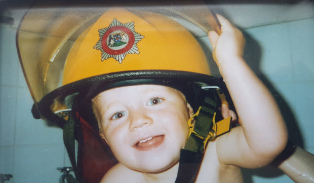 Kobi Poole in his dads helmet as a youngster.
