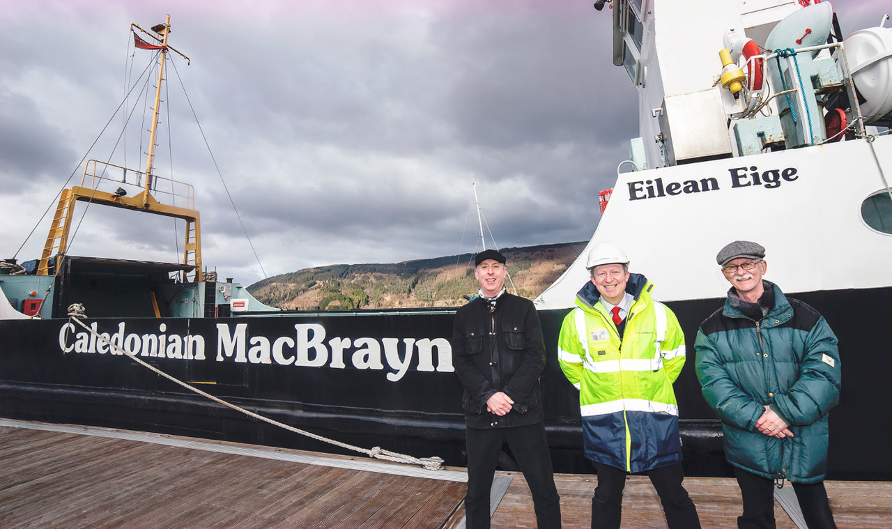 Stuart Craig, left, and Gordon Law of the Clyde River Steamer Club with CalMac’s Jonathan Davies, centre, beside the MV Eigg