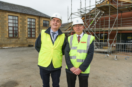 Marc Macrae, planning chairman, and Graham Jarvis, head of lifelong learning, outside the new construction area at Milne's Primary School.