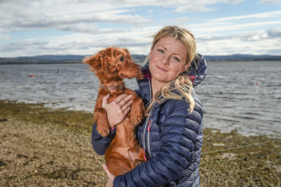 Luna the dog and her owner Sarah Blackburn at the location in Findhorn, Moray, where Luna the dog required a rescue from the coastguard.