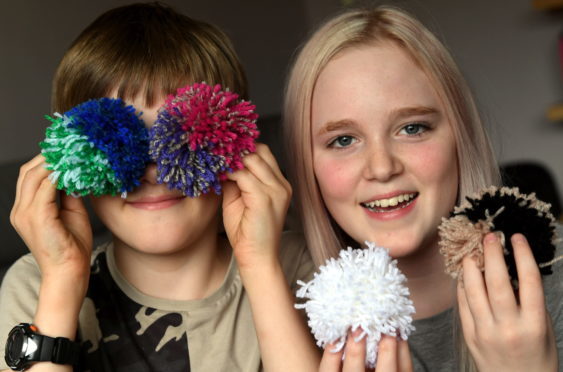 Stonehaven brother and sister Bert and Maddy Mearns, have raised over £1,000 for Cancer Research UK after making pom poms and selling them for donations in the village.