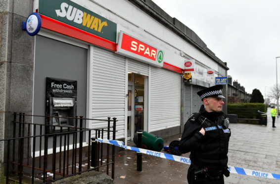Police attend the scene of a robbery at the Spar on Clifton Road last month.