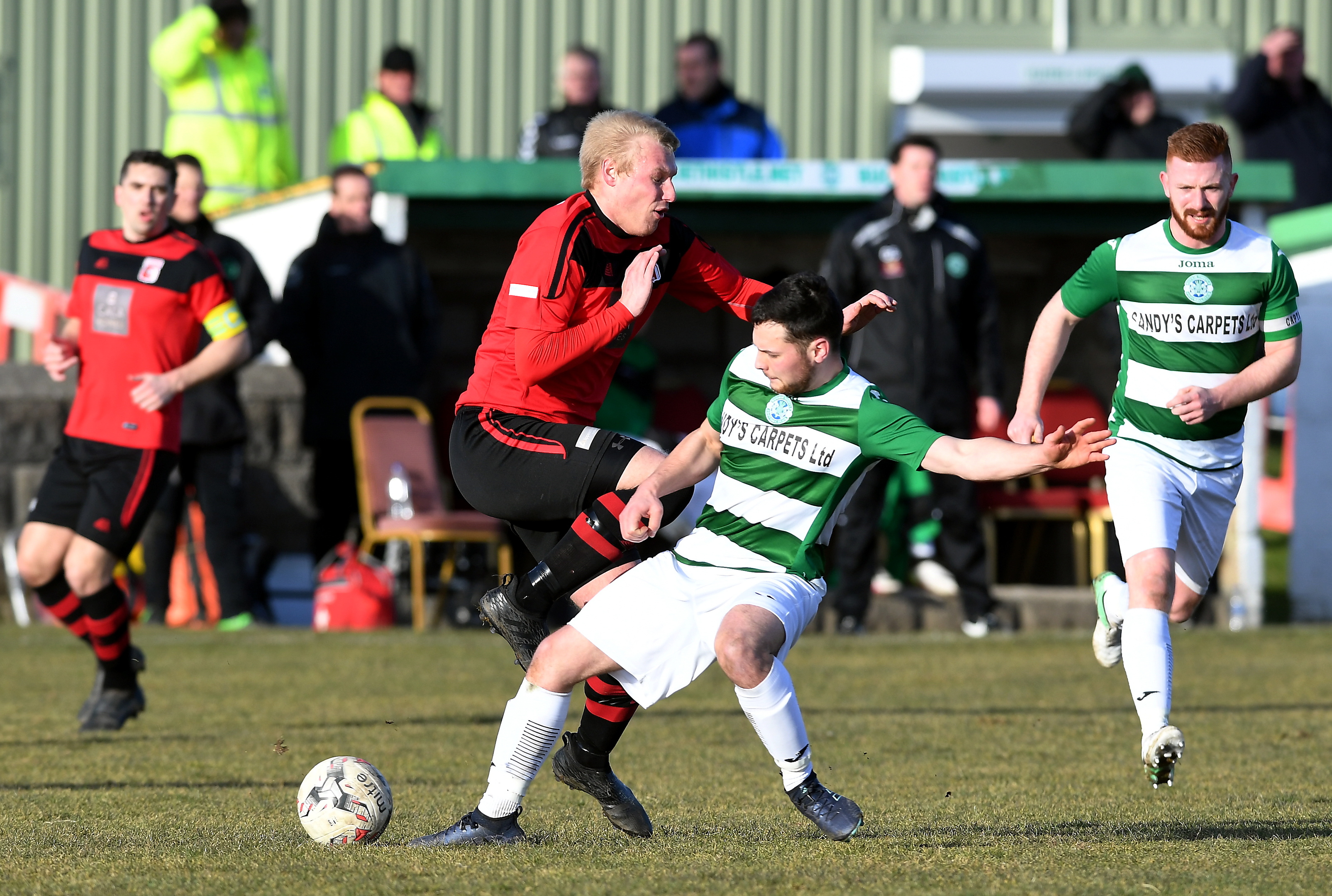 Loco's Chris Angus and Buckie's Andrew Skinner in action.