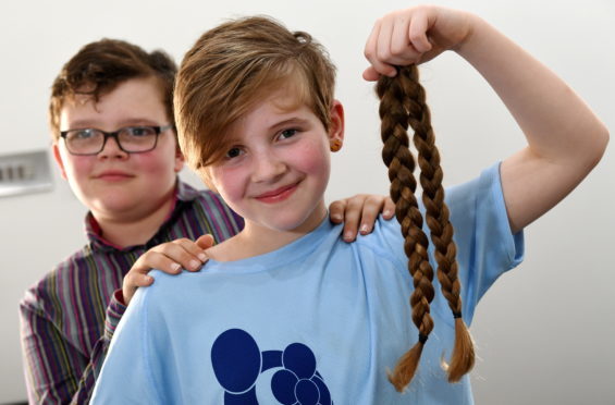 10-year-old Leighann Milne with her brother William after the haircut