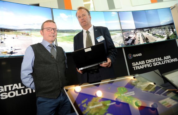 Inglis Lyon (left) Managing Director of HIAL with Per Ahl of Saab as the company demonstrates its use of digital control towers at an exhibition in Inverness yesterday.
Picture by Sandy McCook.