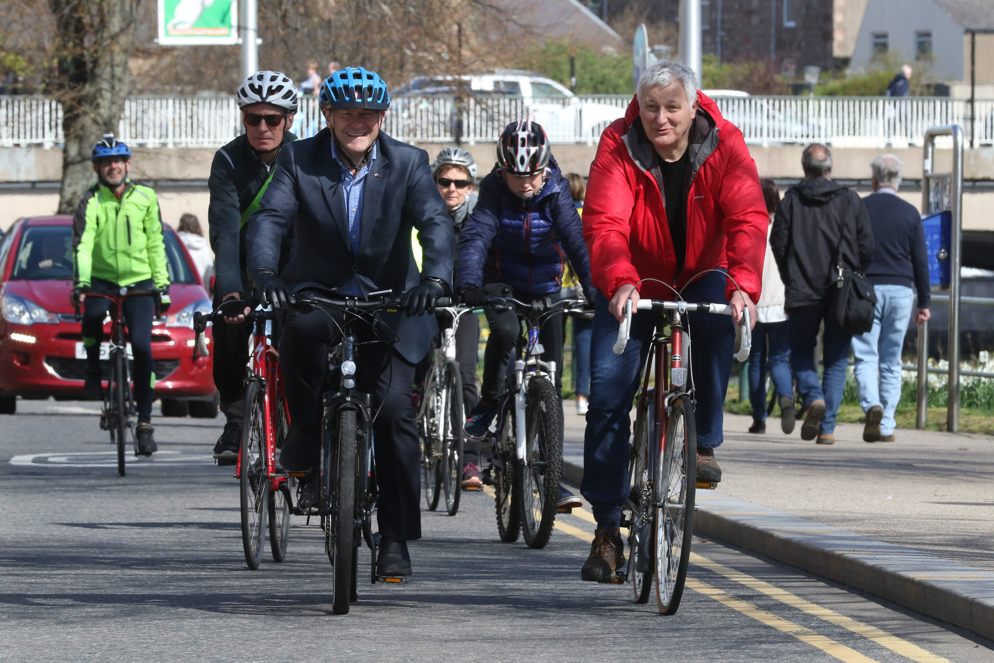Drew Hendry MP and John Finnie MSP lead the procession of cyclists across town to the Highland Council HQ.