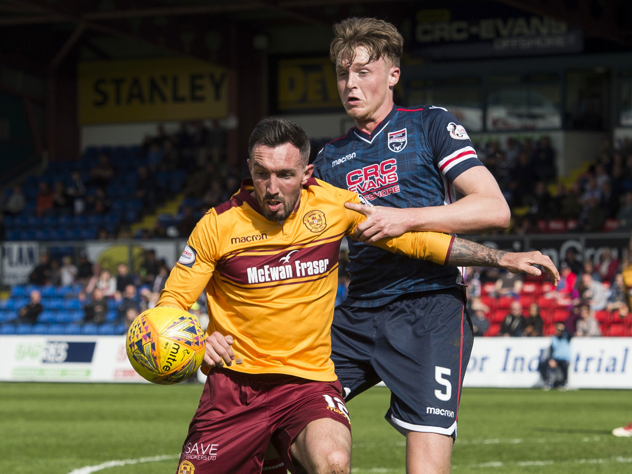 Motherwell's Ryan Bowman (L) in action against Ross Countys Harry Souttar