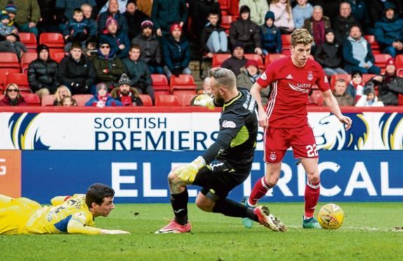 Ryan Christie, right, rounds Saints keeper Alan Mannus and leaves former Don Joe Shaughnessy floored before scoring