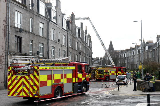 Fire and police crews attending a roof fire on a flat on Victoria Road, Torry.