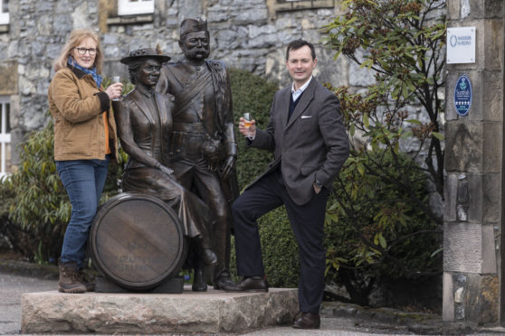 Artist Lois Carson and Peter van Peborgh-Gooch, general manager of William Grant and Sons’ visitor centres, raise a glass to Glenfiddich’s founders.