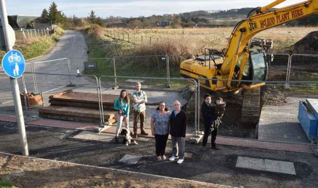 Sandra and Donald McPherson (centre) with neighbours (from left) Laura Martin with dog Guinness, Kieran Wall and Talhah Badriz with son Humayl, 5