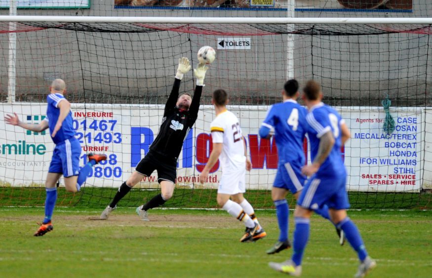 Cove keeper John McCafferty keeping busy during the match.