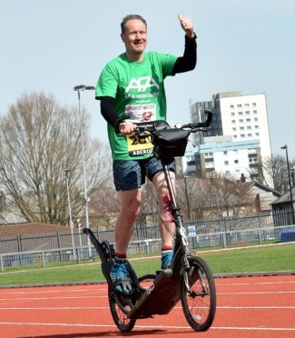 Ian Thom gets on his bike.