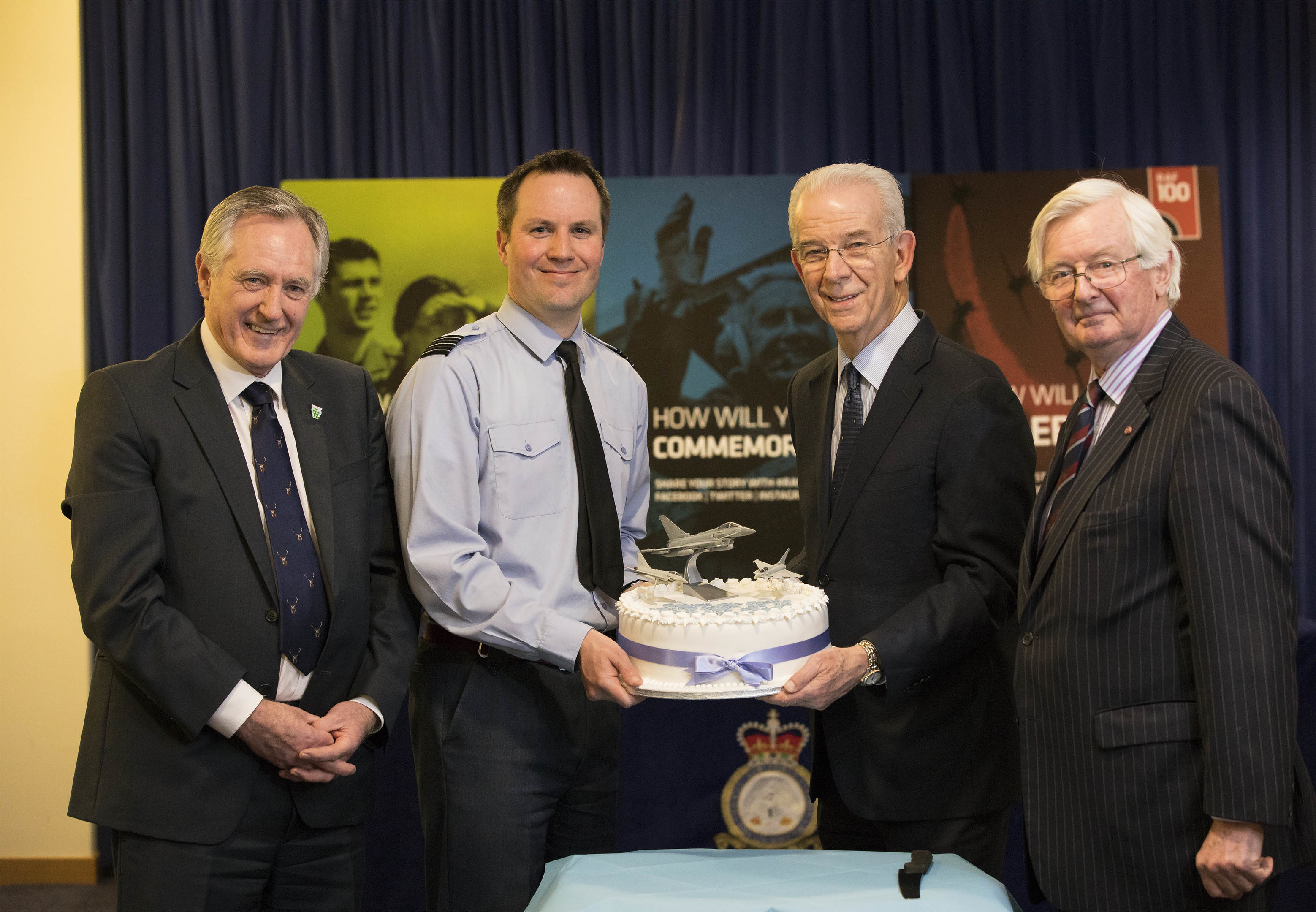 John Cowe, chairman of  Moray Economic Partnership, Wing Commander Matt Hoare, acting Station Commander of RAF Lossiemouth, Jim Walker, joint managing director of Walkers shortbread, and Lt Col Grenville Johnston, Lord Lieutenant of Moray, share cake at the ceremony.