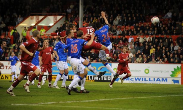Aberdeen striker Lee Miller heads the opening goal for Aberdeen aginst Rangers at Pittodrie. Picture: Raymond Besant.