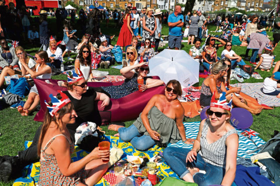 Royal fans gather in Windsor, ahead of the wedding of Prince Harry and Meghan Markle in St George's Chapel at Windsor Castle. PRESS ASSOCIATION Photo. Picture date: Saturday May 19, 2018. See PA story ROYAL Wedding. Photo credit should read: Damir Sagolj/PA Wire